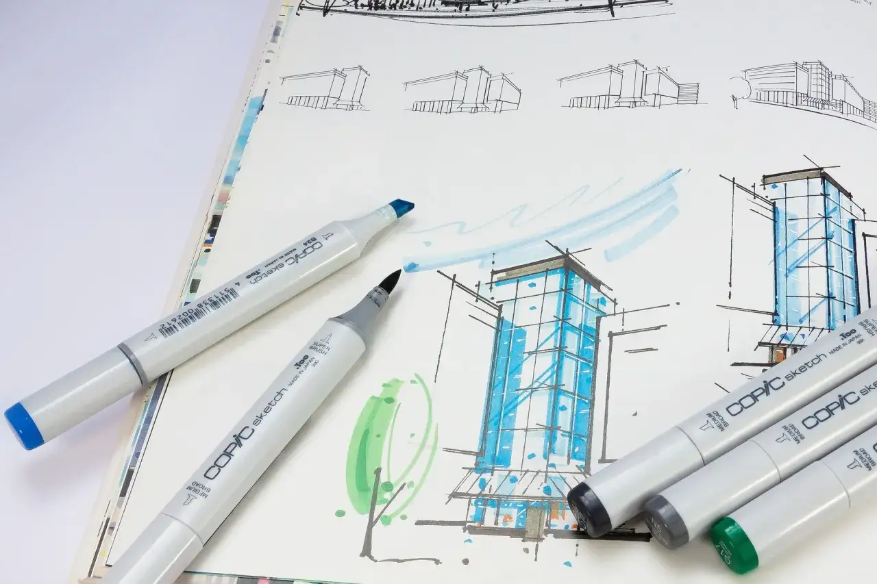 Szkice architektoniczne i markery Copic. Tworzenie własności intelektualnej wymaga precyzji i kreatywności.